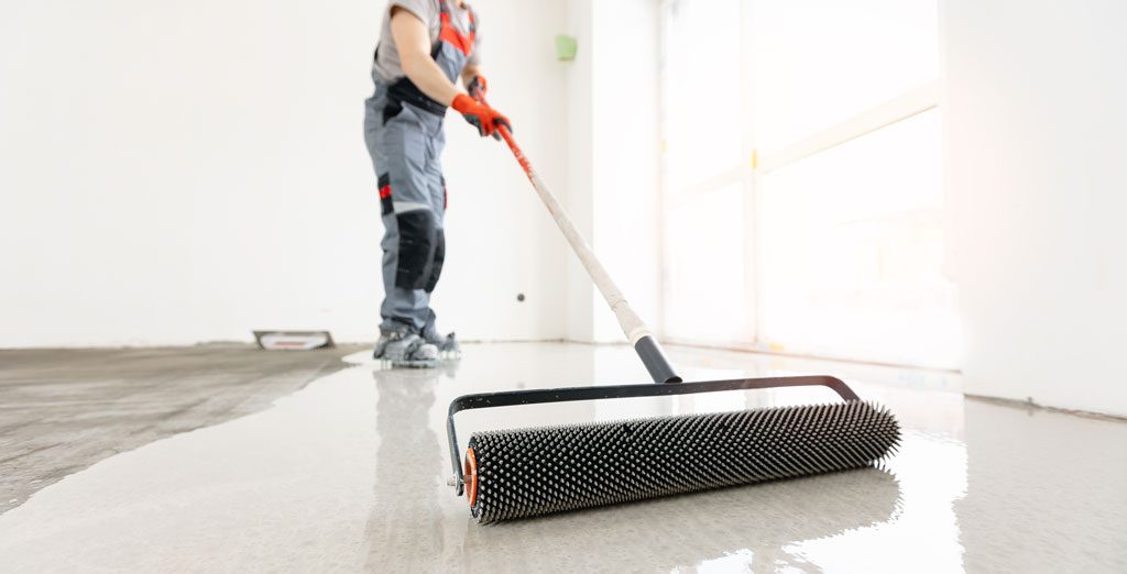 A worker laying an epoxy floor