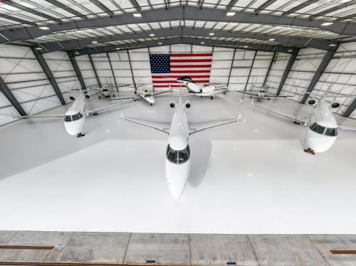 Front View Of Airplane Hangar With Seven Private Planes